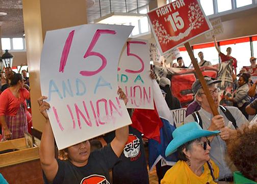 Oakland Fight for 15 activists demonstrate inside a local Burger King