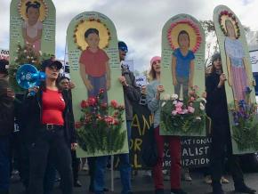 Protesters march in solidarity with the refugee caravan in San Diego